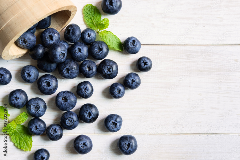 Fresh blueberries on white wooden table Fresh blueberries on white wooden table