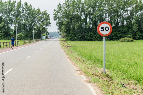 50 kilometers per hour signal and a road