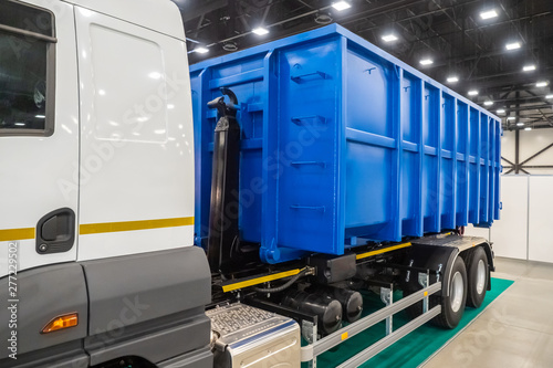 Dump garbage truck. Trailed equipment. Trucks. Special machinery. Transportation of garbage сontainers. Dump truck transportation of waste. Freight transport industry. Garbage collection services.