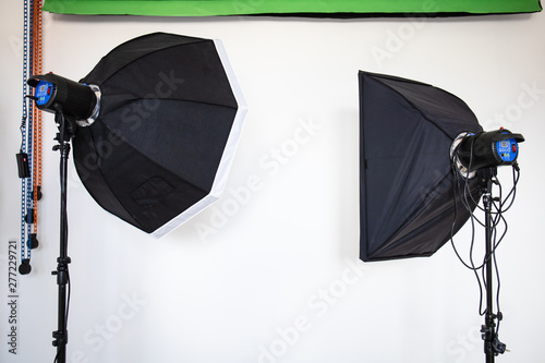 professional studio flashes against a white wall