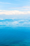Blue sea and sky with white clouds. Beautiful nature background