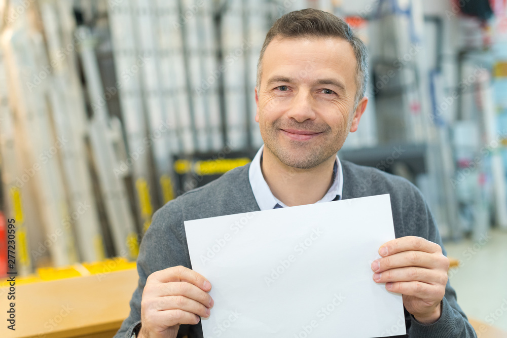 man in casual clothes holding a white sheet