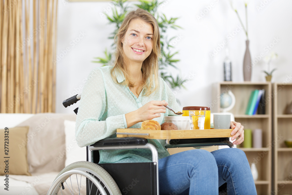 disabled woman in wheelchair having breakfast disabled woman in wheelchair having breakfast