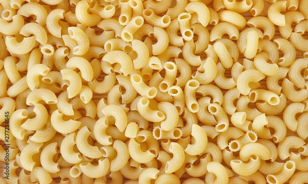Background Textured of Uncooked or Dried Elbow Macaroni Background Textured of Uncooked or Dried Elbow Macaroni
