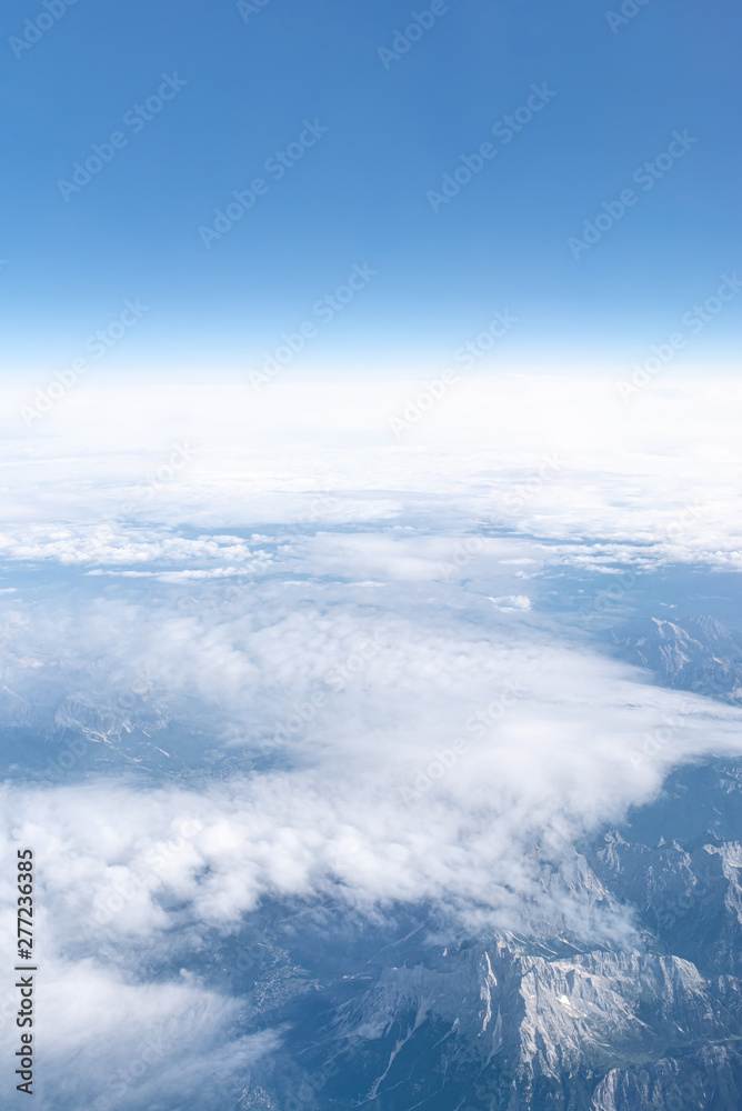 Clouds over Alps mountains, above the clouds, Europe