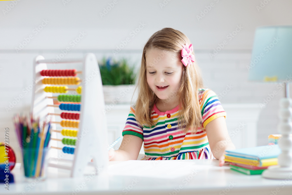 Child with abacus doing homework after school. Child with abacus doing homework after school.