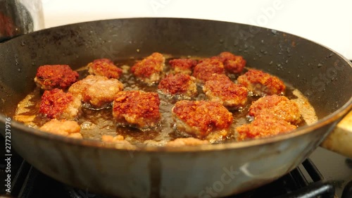 Frying Meatballs in the deep hot oil in the frying pan
