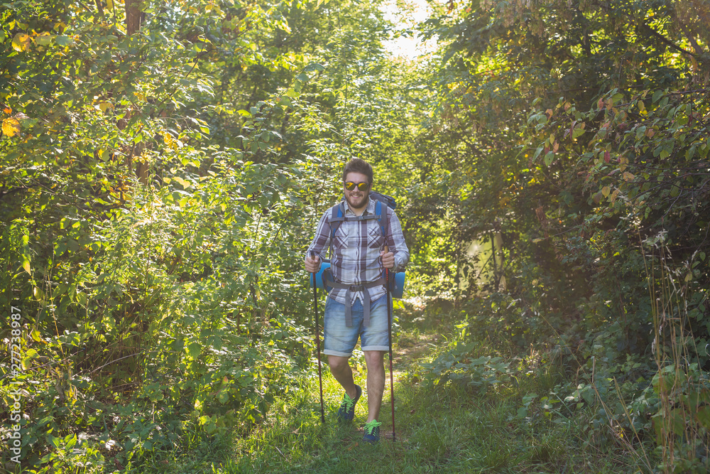 Adventures, summer tourism and nature concept - tourist arriving to a camping with his cat