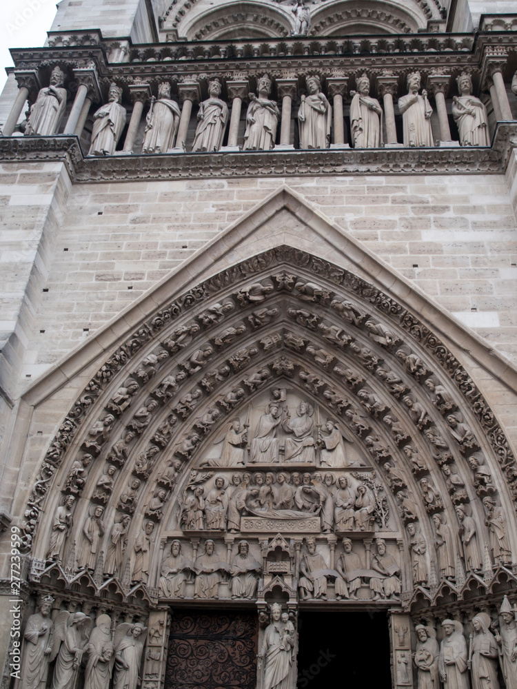 Fragment of the front elevation with the entrance to the Notre Dame cathedral in Paris