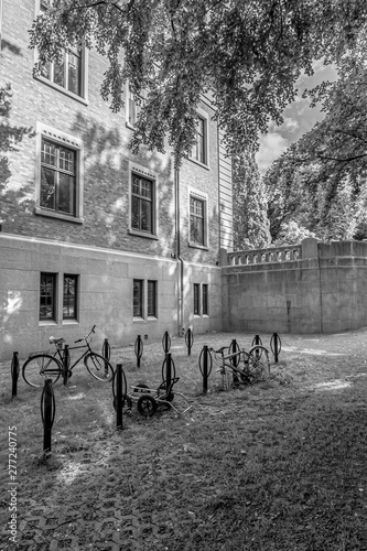 Bicycle parking outside a large stone building.