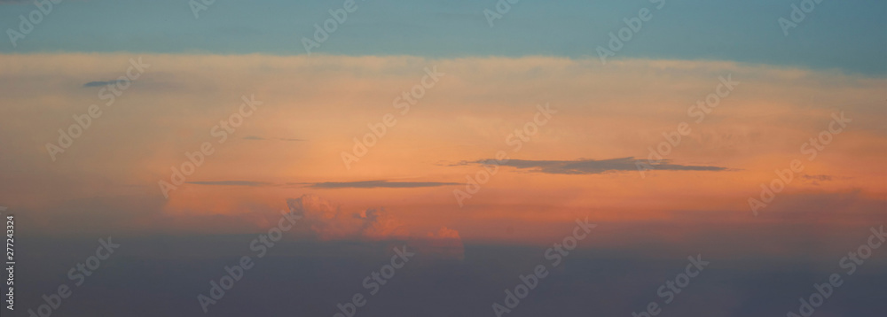 Evening sky with clouds in soft colors. Orange sky.