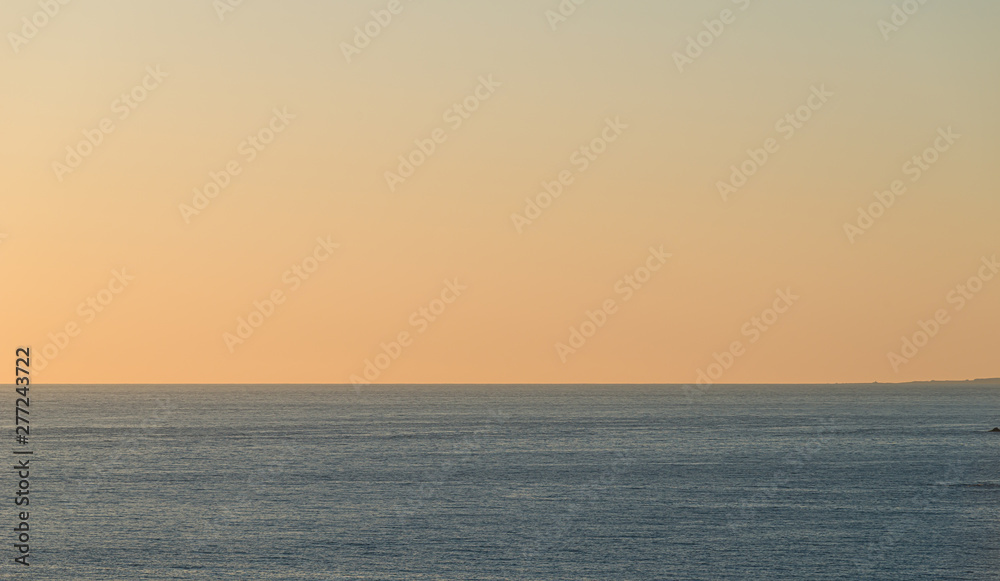 Calm sea at a beautiful orange sunset.