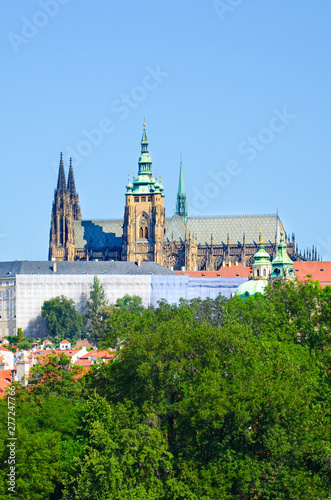 Beautiful Prague Castle with St. Vitus Cathedral, Bohemia, Czech Republic surrounded by historical old town and green trees. Hradcany, Praga, Czechia. European cities