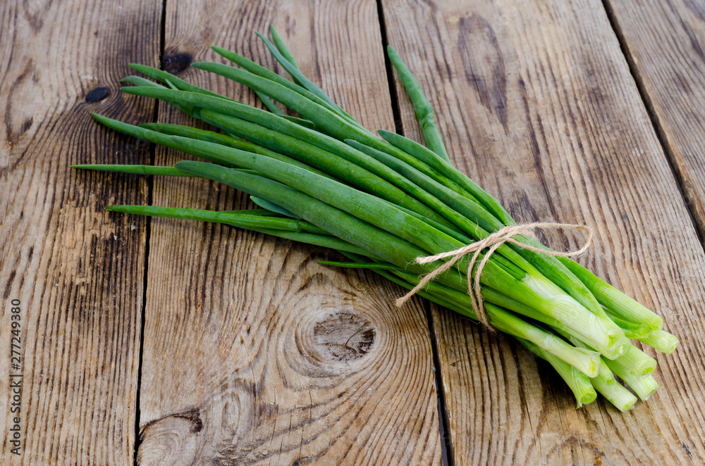 Bunch of fresh green onions on wooden table. Bunch of fresh green onions on wooden table.