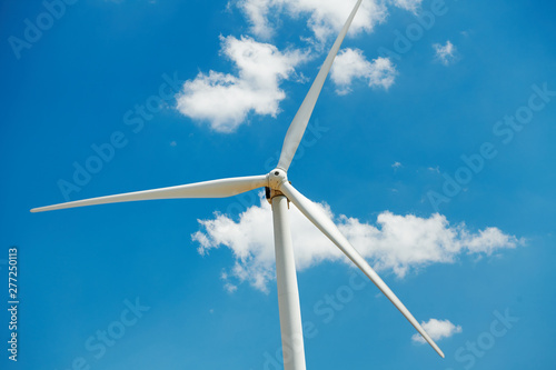 Electricity wind generator on bright cloudy sky background - wind energy and technology concept © soleg