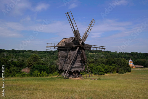 Old windmill. Ukrainian mill of the nineteenth century. Summer landscape, sunshine. Village Pirogovo.