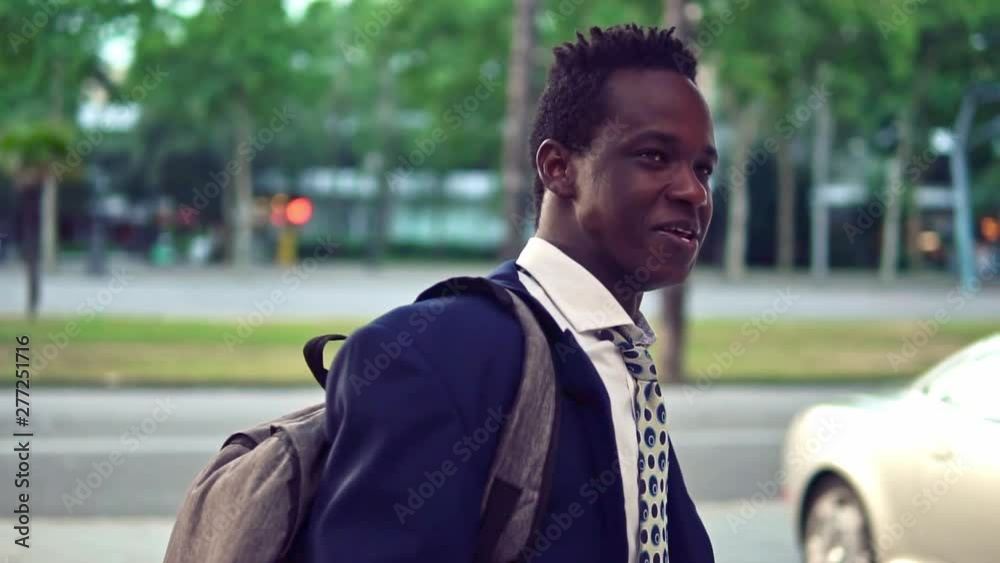 African American businessman wearing blue suit and backpack. Business concept African American businessman wearing blue suit and backpack. Business concept