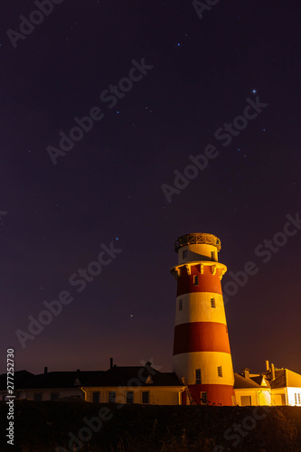 lighthouse on the sea against the night sky