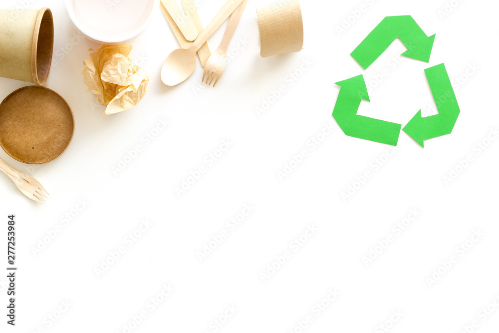 Recycling symbol and different garbage, cup, flatware for ecology on white background top view mock up