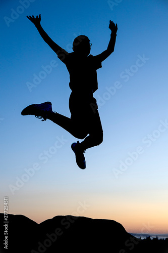 Jumping for joy at sunset.