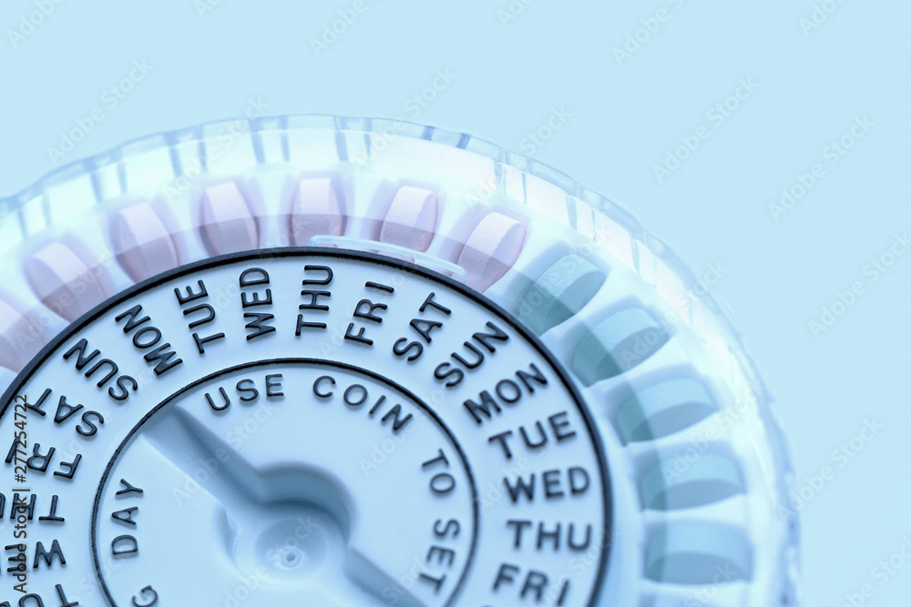 Closeup of birth control pill dispenser showing days of the week Closeup of birth control pill dispenser showing days of the week