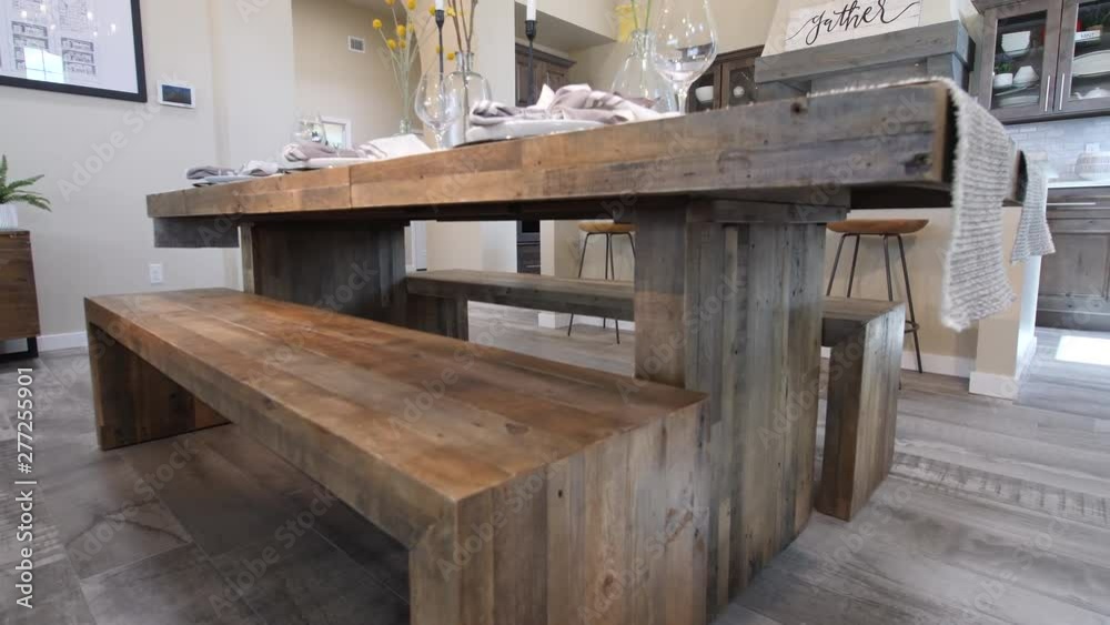 Dining Table Rise to Reveal Kitchen Wide Angle. view moves up a dining table with kitchen in the background