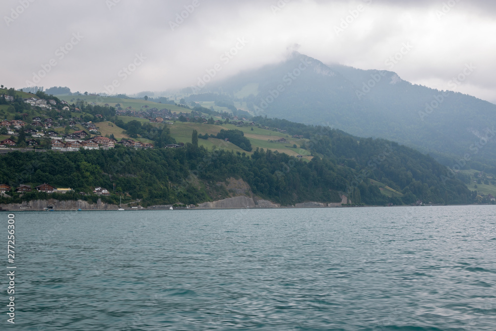 View on lake Thun and mountains from ship in city Spiez, Switzerland