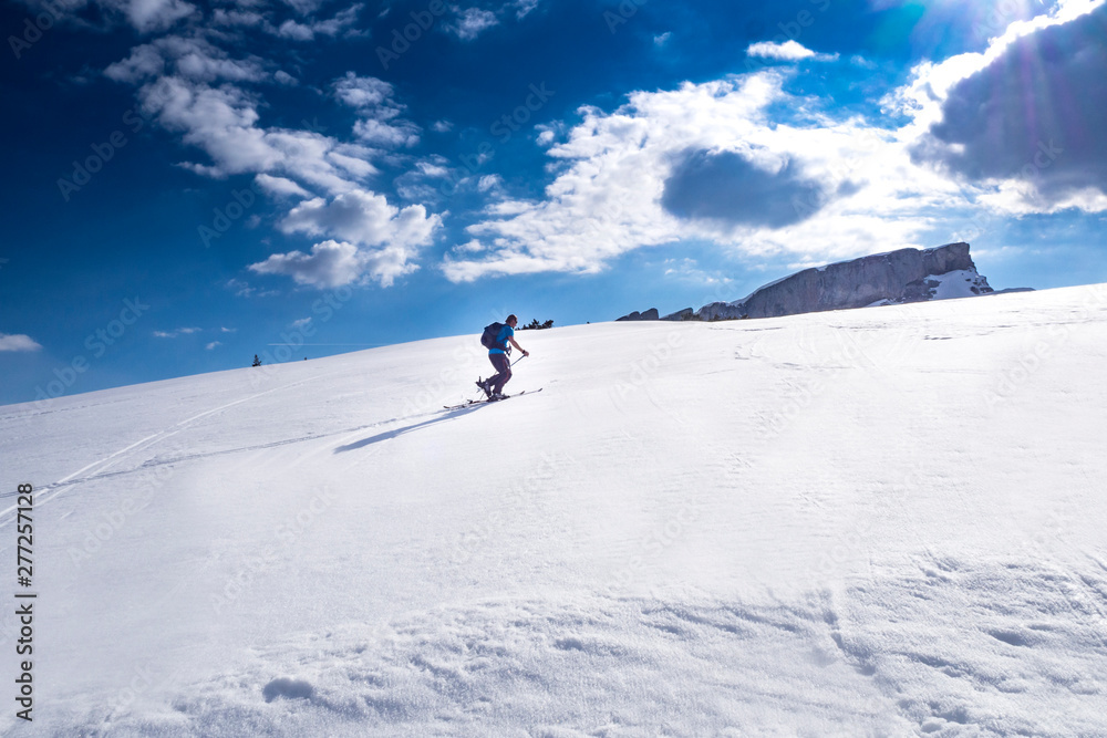 Ski tourer in the alps ascending