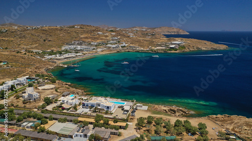 Fototapeta Naklejka Na Ścianę i Meble -  Aerial drone bird's eye view from famous beach of Paraga and Agia Anna featuring iconic Skorpios club and Santa Anna with largest pool in Europe, Mykonos island, Cyclades, Greece