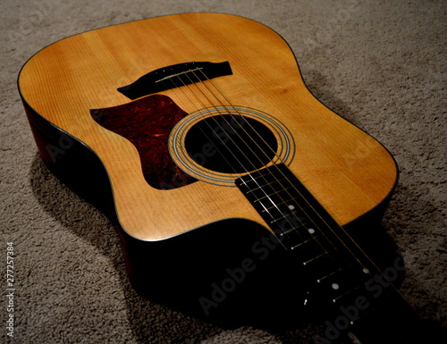 View Looking Down of the Body of an Acoustic Guitar on a Neutral Background with Beutful Wood