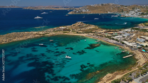 Aerial drone bird s eye view from famous beach of Paraga and Agia Anna featuring iconic Skorpios club and Santa Anna with largest pool in Europe  Mykonos island  Cyclades  Greece
