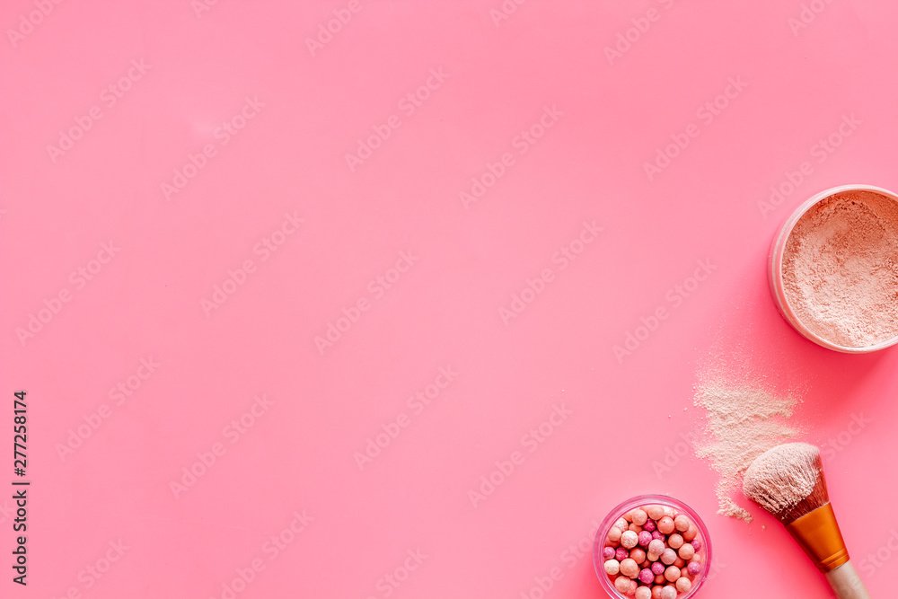 Women desk with brushes, powder and blusher for make up on pink background flat lay space for text Women desk with brushes, powder and blusher for make up on pink background flat lay space for text