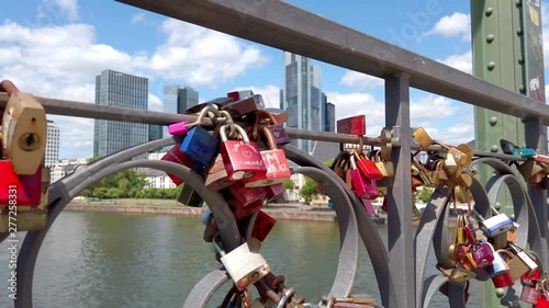 View of colorful locks of love on the Eiserner Steg (Iron Bridge) over the Main river in Frankfurt, July 2019 photo