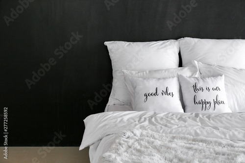 Fototapeta Naklejka Na Ścianę i Meble -  Comfortable bed near dark wall