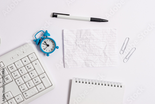 Copy space on the empty note paper with pc keyboard clock and pencil on the table.