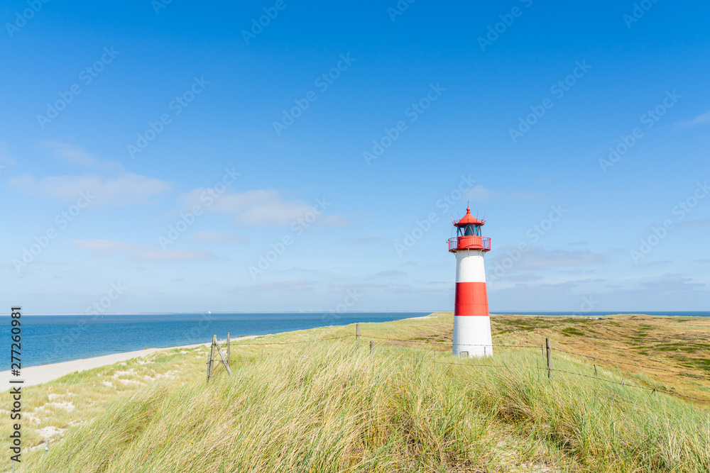 Lighthouse red white on dune. Sylt island – North Germany. Lighthouse red white on dune. Sylt island – North Germany.