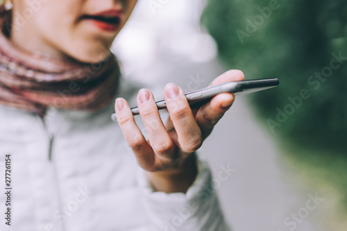 Tablou pe pânză Close up of female hand holding smartphone