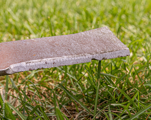 lawn mower blade that is rusty, damaged, dull and needs sharpened