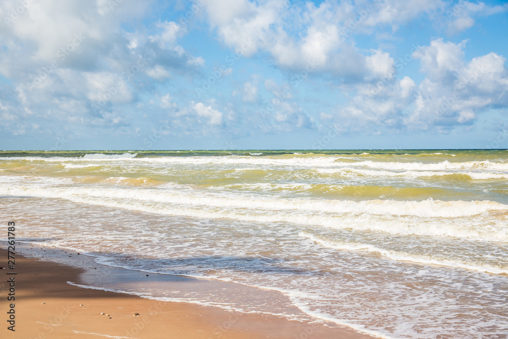 Baltic sea shore in Latvia. Landscape of beach and sea with blue sky Baltic sea shore in Latvia. Landscape of beach and sea with blue sky
