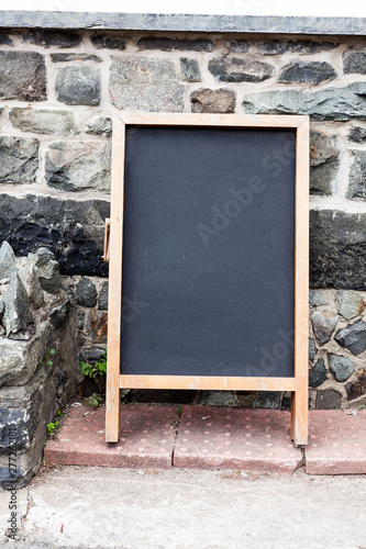 Empty black board with copy space for advertising. Blank dark board with empty space for text.