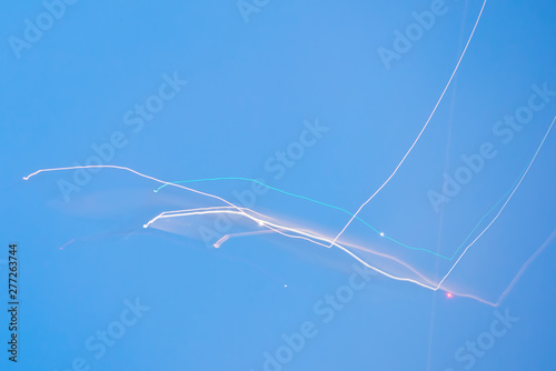 Abstract long exposure background with neon colored light streaks