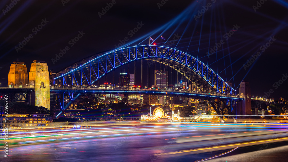 Sydney Harbour Bridge and Sydney Harbour lit up with colorful lights at the Vivid Festival