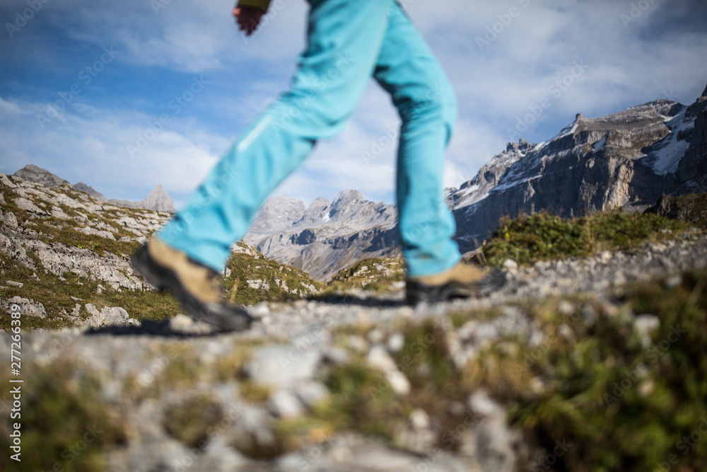 Pretty, young female hiker walking in high mountains (shallow DOF) Pretty, young female hiker walking in high mountains (shallow DOF)