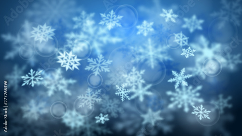 Christmas blurred background of complex defocused big and small falling snowflakes in blue colors with bokeh effect