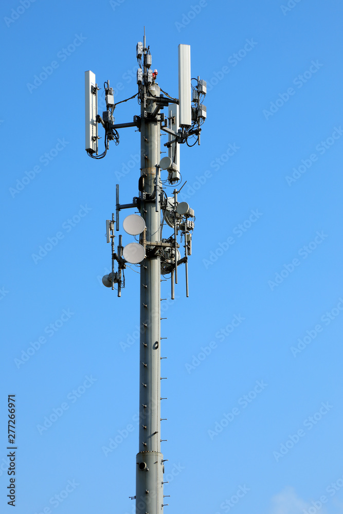 close up communication tower over sunny blue sky close up communication tower over sunny blue sky