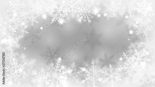 Christmas blurred background with frame of complex defocused big and small snowflakes in white and gray colors with bokeh effect