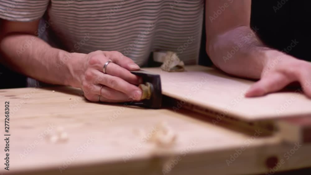 Carpenter planing wood board Carpenter planing wood board