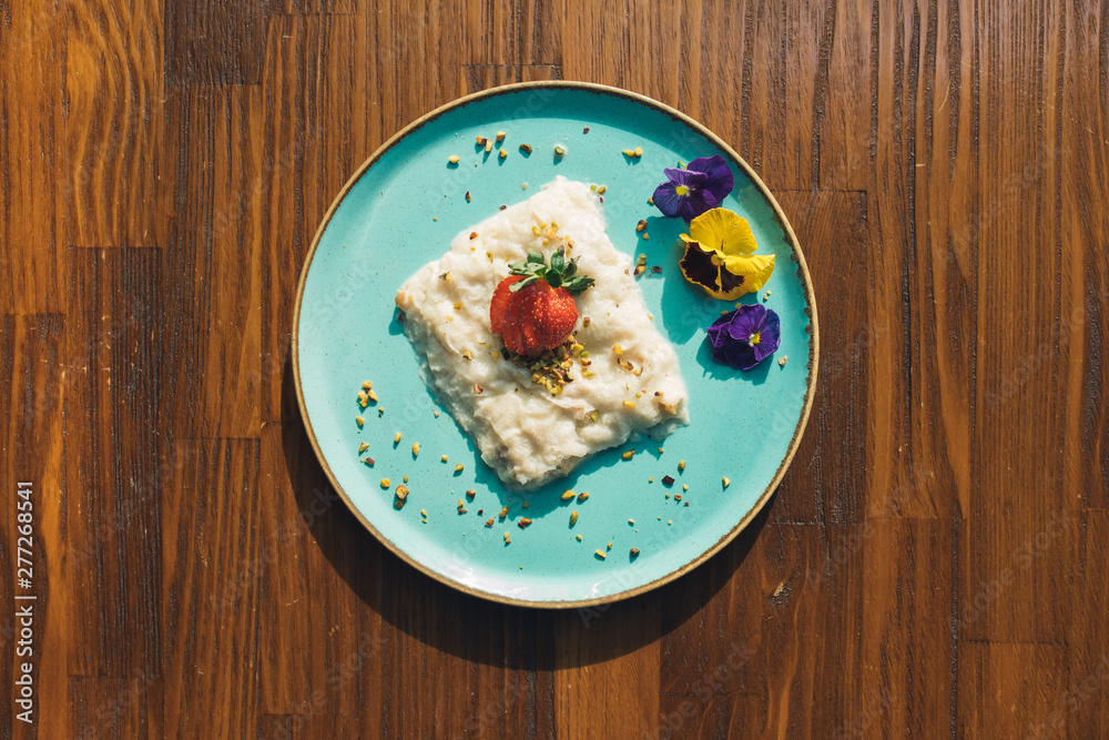 Traditional Turkish Milk dessert Gullac or baklava dough on wooden table. This is also Ramadan dessert.