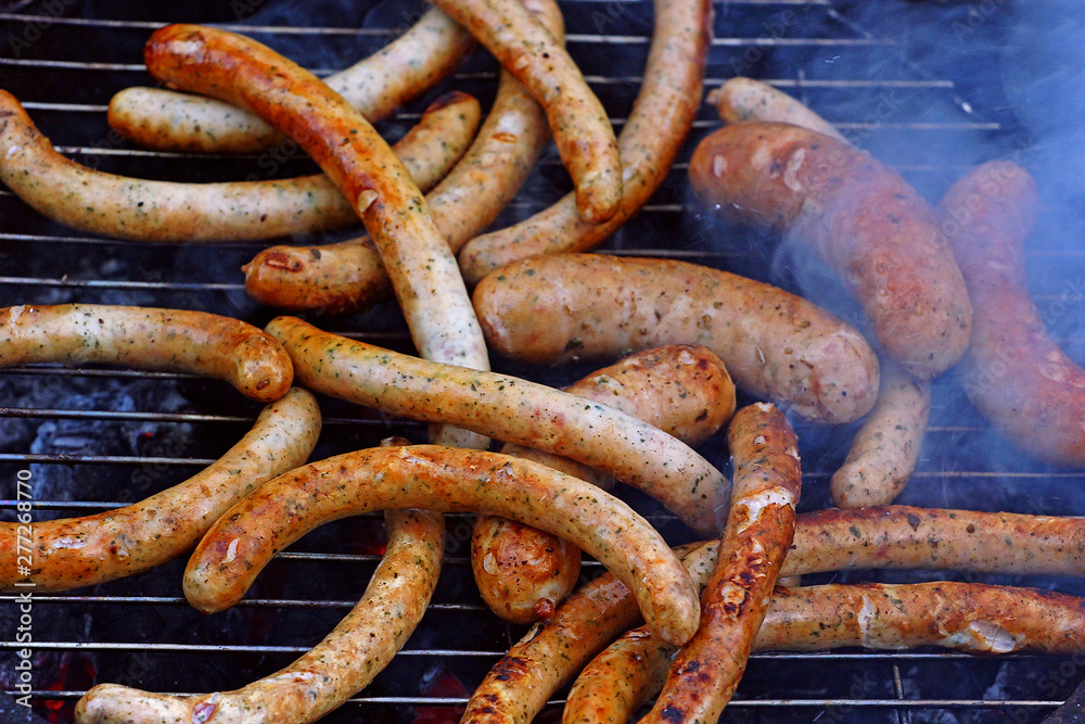 grill sausages and wieners on the grill in the smoke grill sausages and wieners on the grill in the smoke