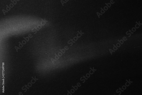 black paper texture or background with spotlight, dark wall backdrop wallpaper, dark tone.